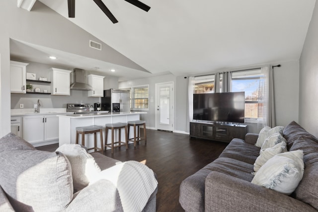 living room featuring ceiling fan, sink, lofted ceiling, and dark wood-type flooring