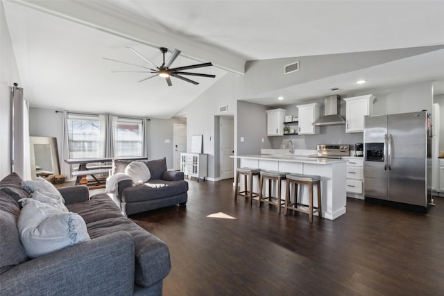 living room with ceiling fan, sink, dark hardwood / wood-style flooring, and lofted ceiling with beams