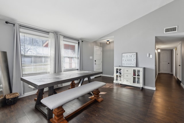 dining room featuring dark hardwood / wood-style floors and lofted ceiling