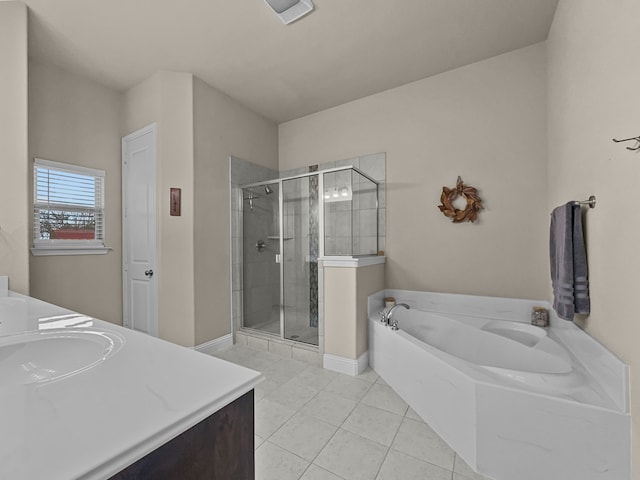 bathroom featuring plus walk in shower, vanity, and tile patterned flooring