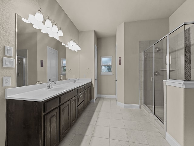 bathroom with tile patterned flooring, vanity, and a shower with shower door