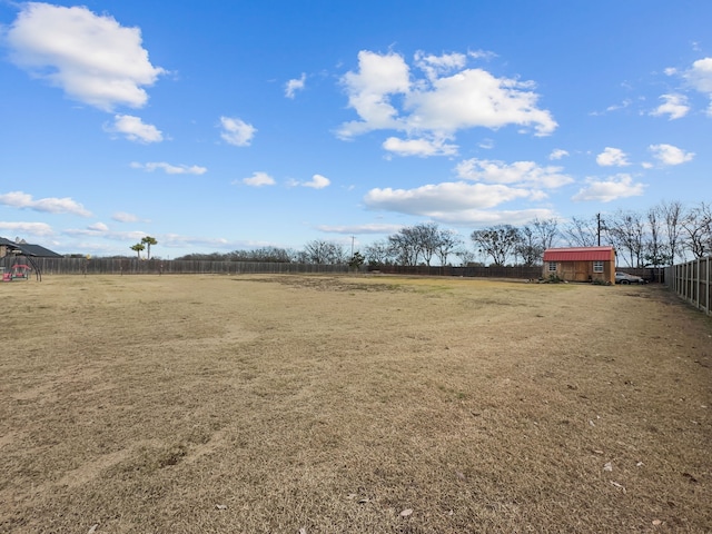 view of yard with a rural view and an outbuilding