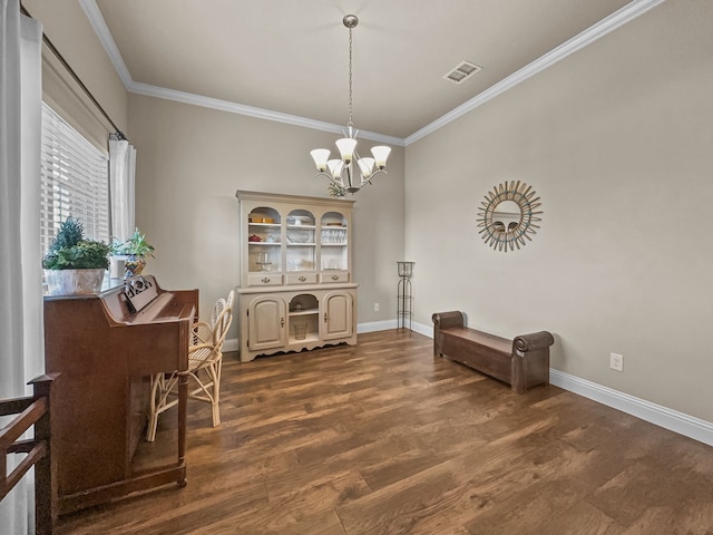 dining room with crown molding, dark wood-type flooring, and an inviting chandelier