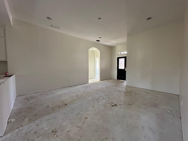612 N US Highway 69, Celeste, TX 75423 - unfurnished living room with concrete flooring and arched walkways