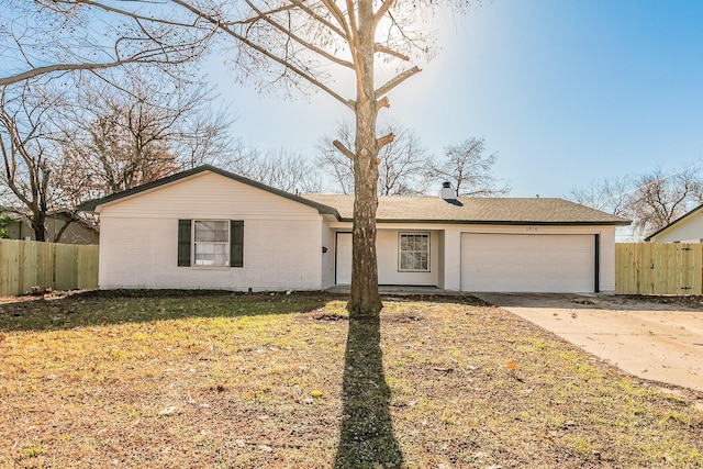 ranch-style house with a garage and a front yard