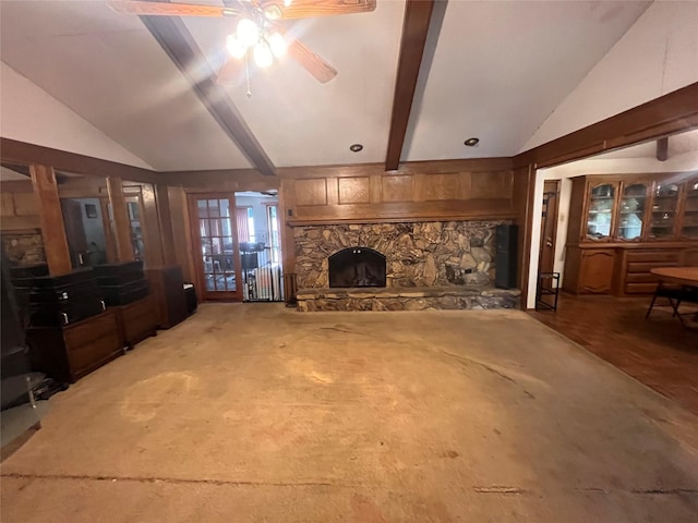 living room featuring beam ceiling, ceiling fan, french doors, a fireplace, and carpet