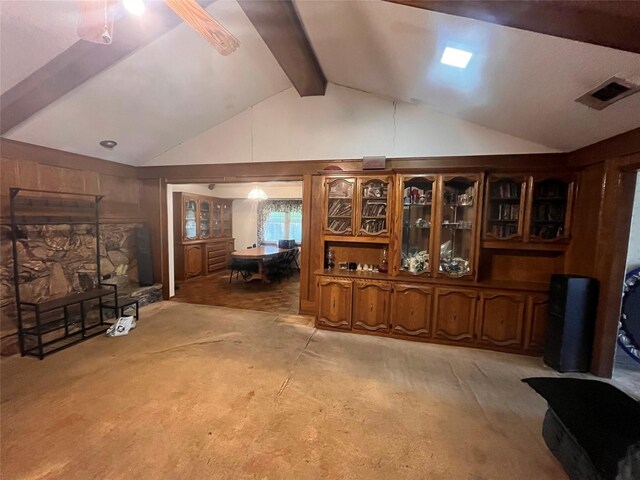 carpeted living room featuring vaulted ceiling with beams