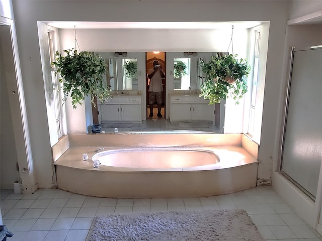 bathroom featuring tile patterned floors, vanity, and shower with separate bathtub