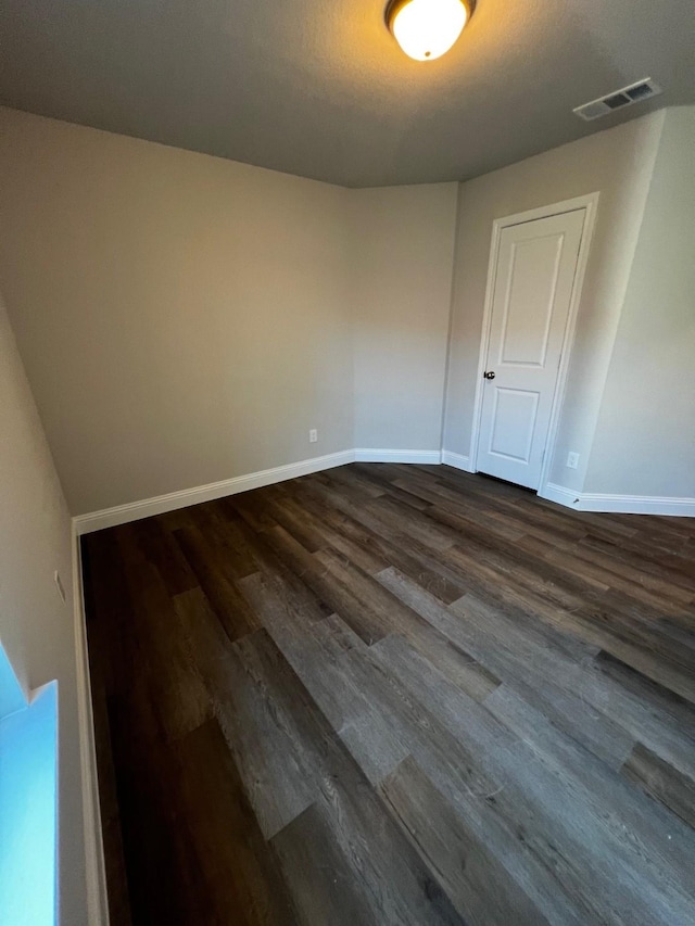 spare room with dark hardwood / wood-style floors