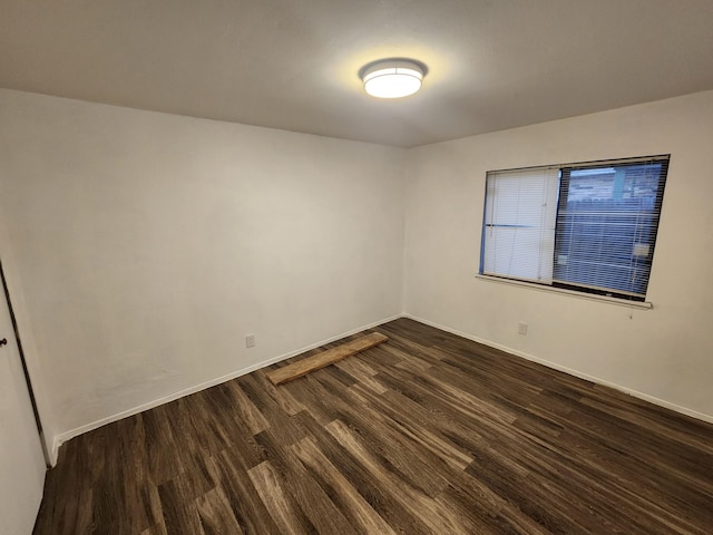 empty room with dark hardwood / wood-style flooring