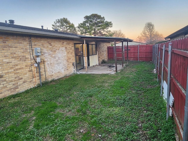 yard at dusk with a patio