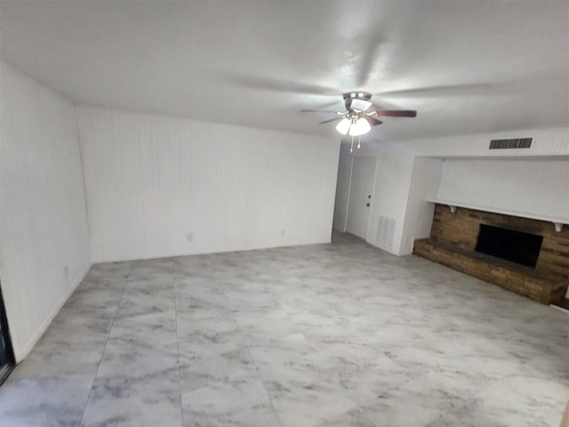 unfurnished living room featuring a fireplace and ceiling fan