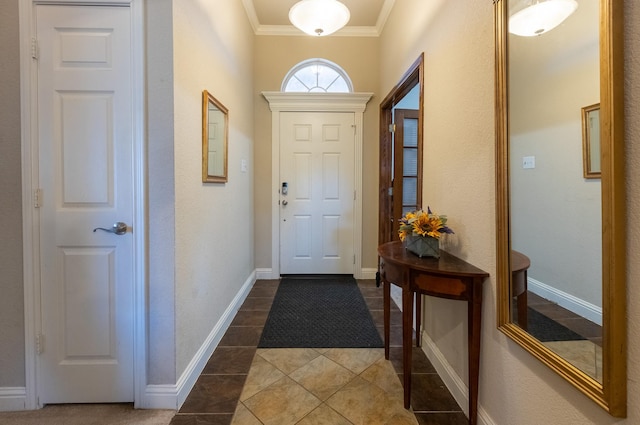 entryway featuring dark tile patterned floors and crown molding