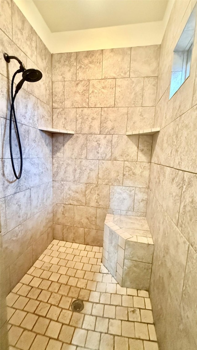 bathroom with a tile shower