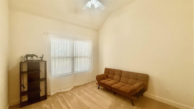 living area with vaulted ceiling, ceiling fan, and carpet floors