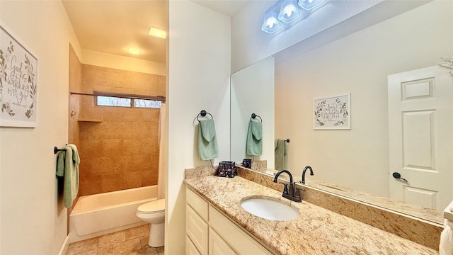 full bathroom with vanity, tiled shower / bath combo, and toilet