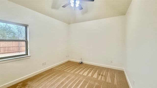 carpeted spare room with plenty of natural light and ceiling fan