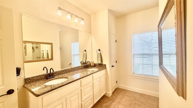 1505 Cross Oaks Ct, Graham, TX 76450 - bathroom featuring double vanity and baseboards