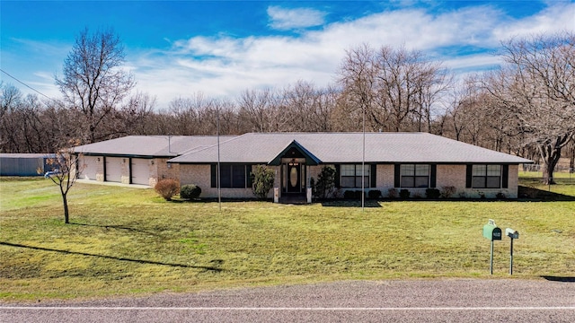 single story home featuring a garage and a front yard