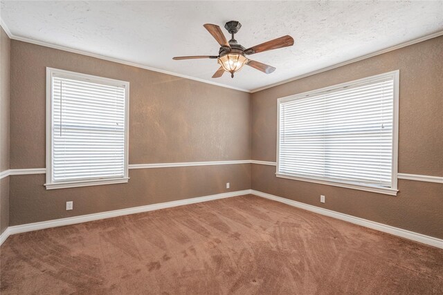 carpeted empty room featuring ornamental molding, a textured ceiling, and ceiling fan