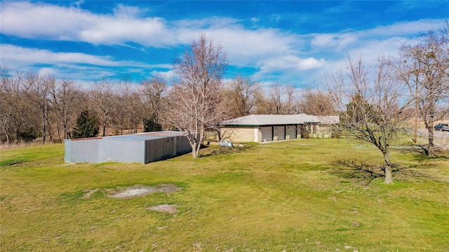 view of yard with an outbuilding and a pole building