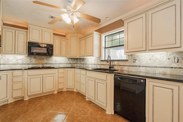 kitchen featuring cream cabinetry, dark stone counters, sink, and black appliances