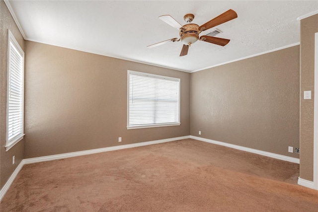 carpeted empty room with ornamental molding and ceiling fan