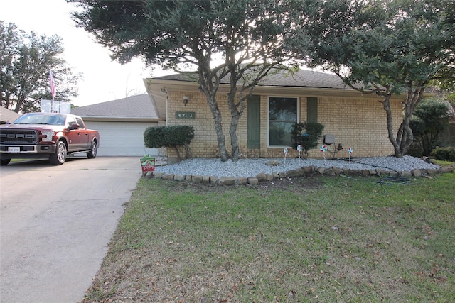 ranch-style home with a garage and a front yard