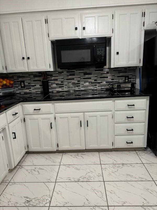 kitchen featuring backsplash and white cabinets