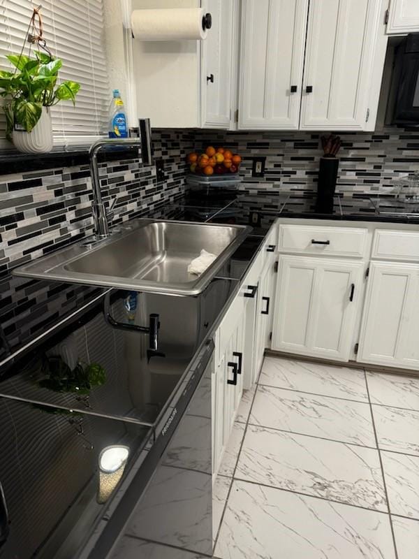 kitchen with sink, decorative backsplash, and white cabinets