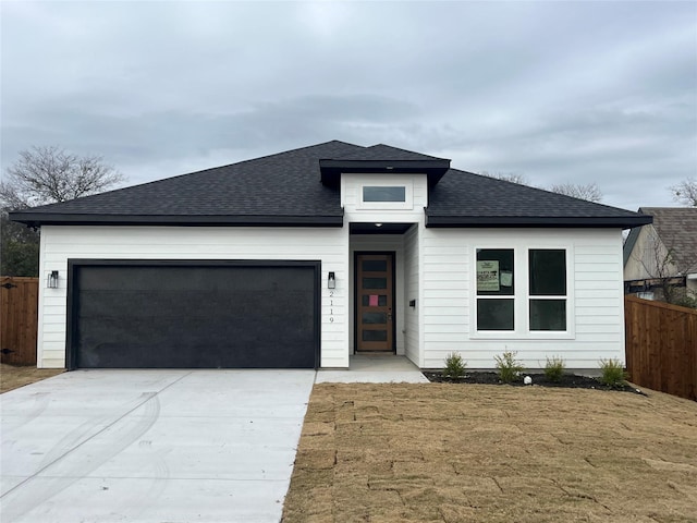 view of front of home with a front lawn and a garage