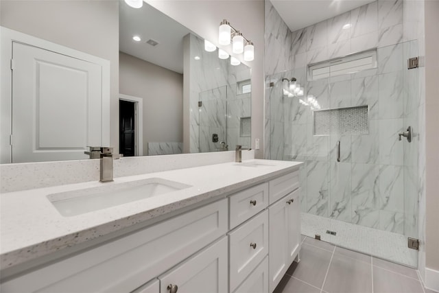 bathroom featuring tile patterned flooring, vanity, and an enclosed shower