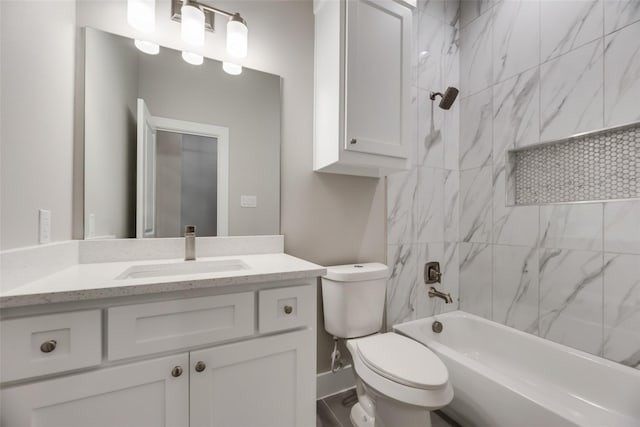 full bathroom with vanity, toilet, and tiled shower / bath