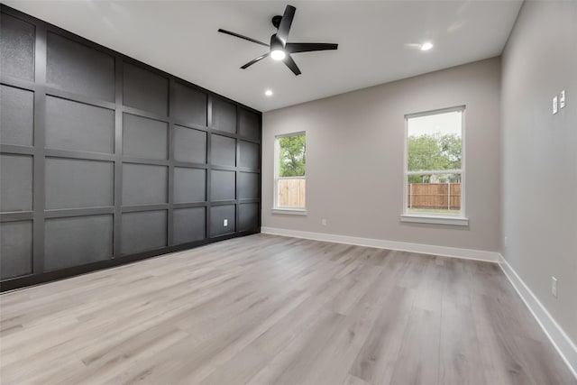 spare room featuring light wood-type flooring and ceiling fan