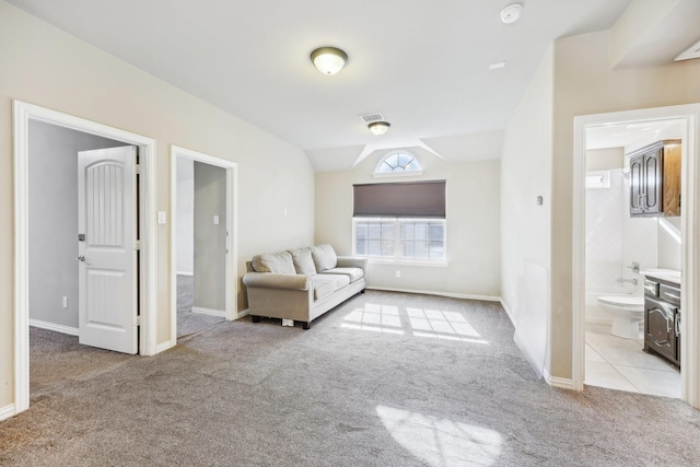 unfurnished living room featuring light colored carpet and lofted ceiling