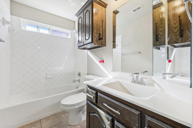 full bathroom featuring tile patterned flooring, vanity, toilet, and tiled shower / bath