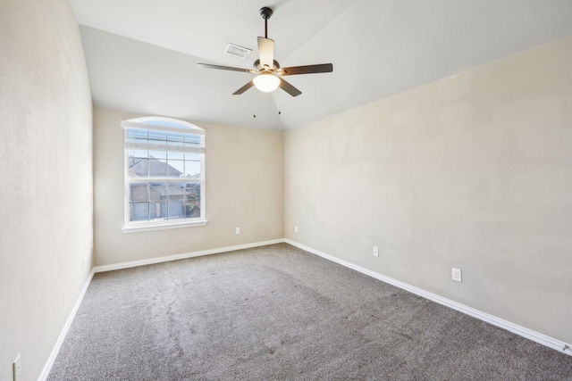 spare room with ceiling fan, carpet, and vaulted ceiling