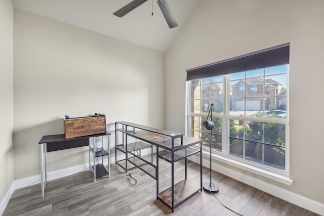 home office with ceiling fan, vaulted ceiling, and hardwood / wood-style flooring