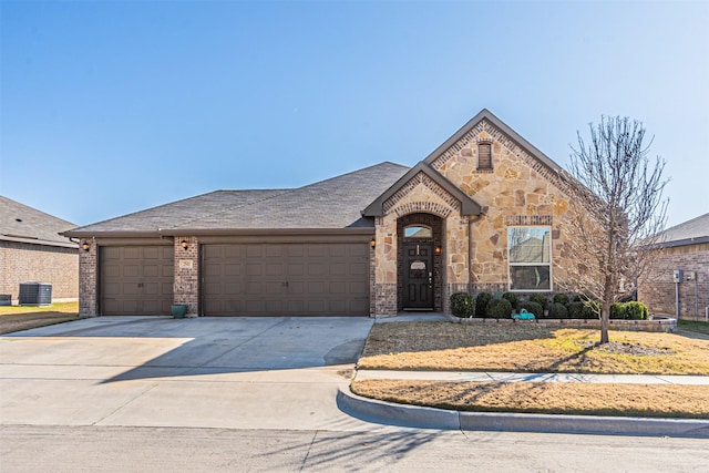 view of front of property with central AC and a garage