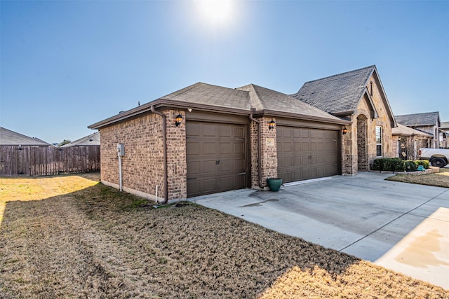 view of side of property with a yard and a garage