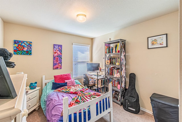 bedroom with carpet floors and a textured ceiling