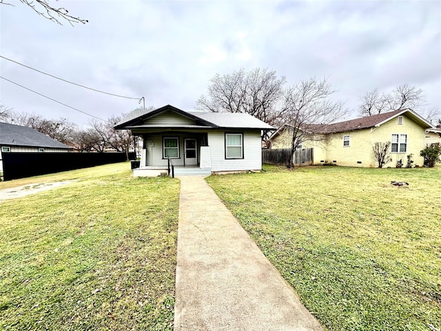 bungalow-style home with a front lawn and covered porch