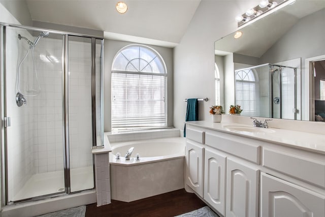 bathroom with lofted ceiling, shower with separate bathtub, wood-type flooring, and vanity