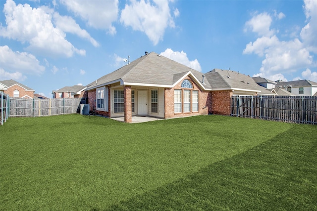 rear view of property featuring a yard, central AC, and a patio