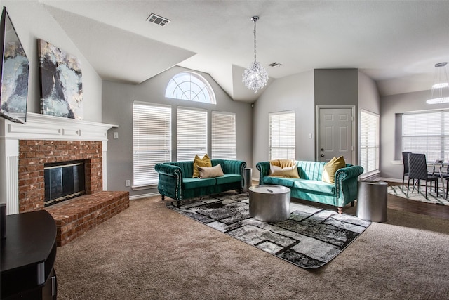 carpeted living room featuring a chandelier, a brick fireplace, and lofted ceiling