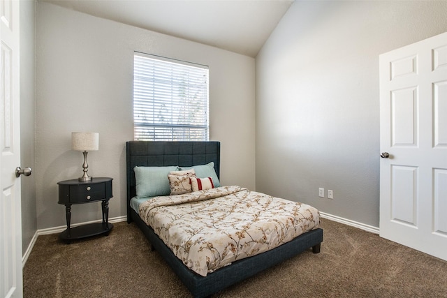 bedroom with dark carpet and vaulted ceiling