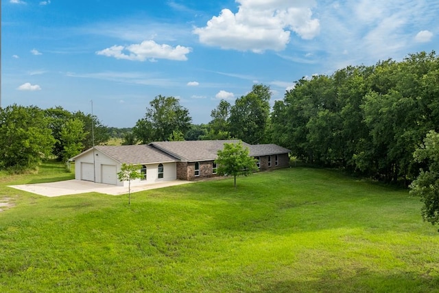 ranch-style house featuring a garage and a front lawn