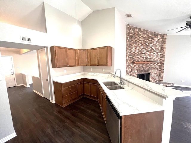 kitchen featuring dishwasher, sink, light stone counters, high vaulted ceiling, and kitchen peninsula