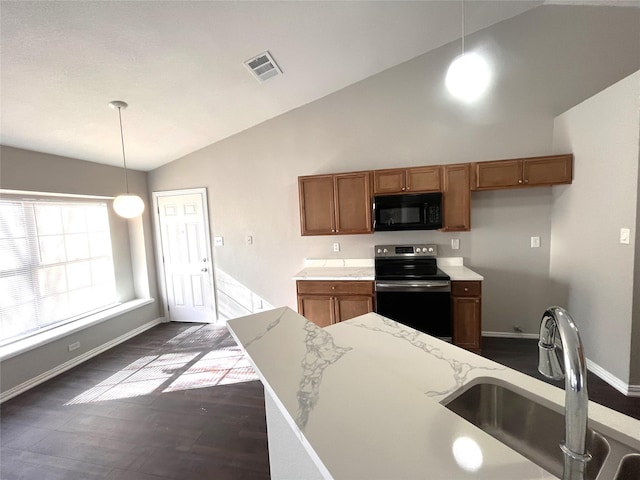 kitchen with sink, dark hardwood / wood-style floors, pendant lighting, vaulted ceiling, and electric stove