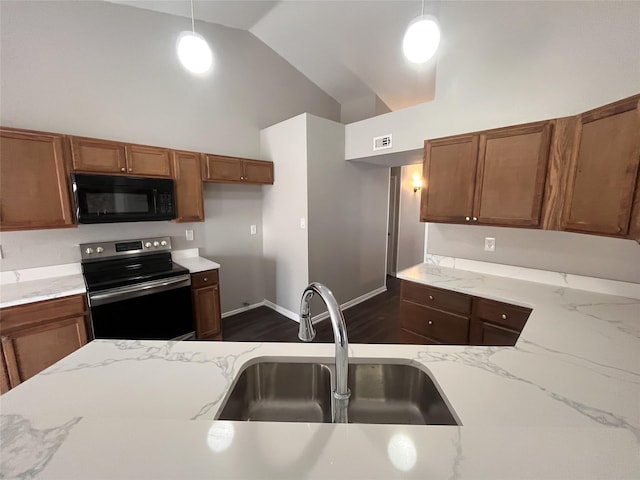 kitchen with pendant lighting, stainless steel electric range, light stone counters, and sink